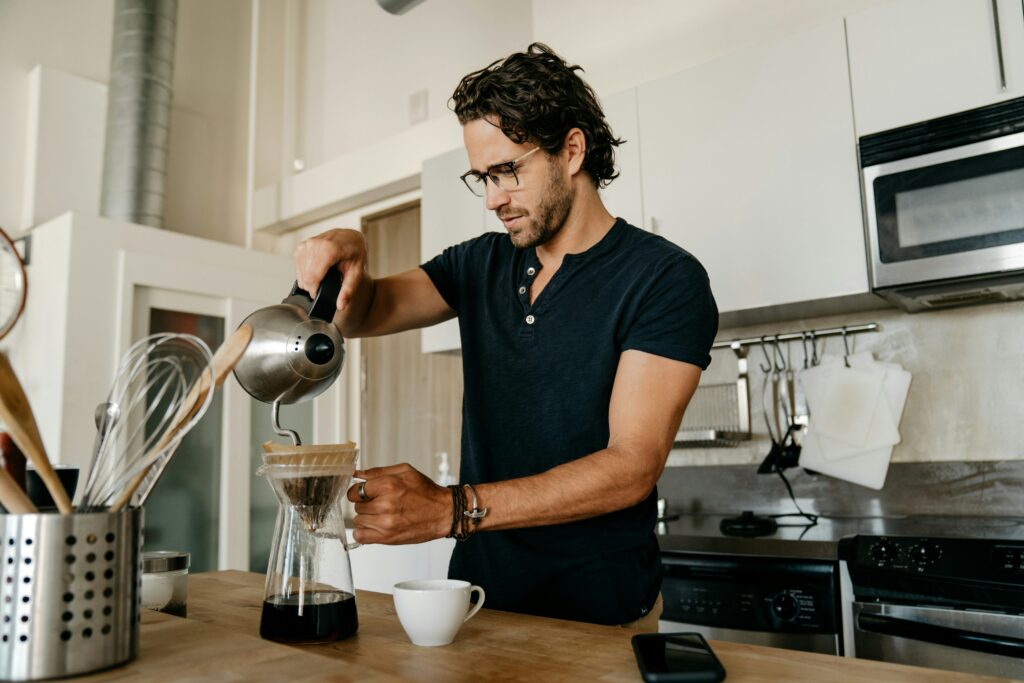 Man pouring coffee, starting his day with a routine 